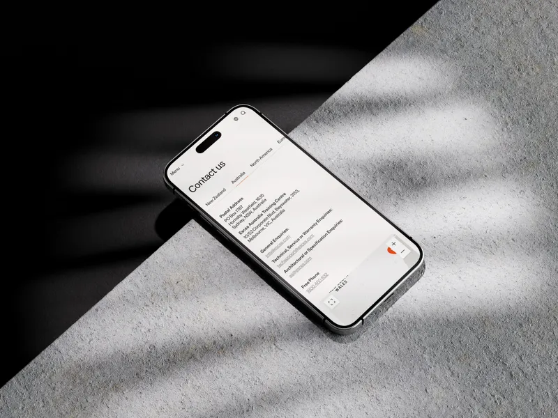 The Escea website on a phone on concrete