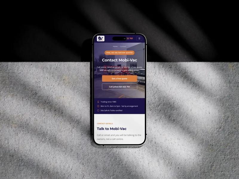 The Mobi-Vac website on a phone on concrete